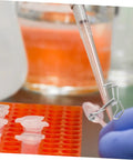 Lab setup with Flow Control Tubing Clamps Pack Of 10, Spring Water Stop Clips, used during a pipetting process in a test tube rack
