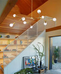 Gold 9 Light Sputnik Chandelier Modern Metal Ceiling Hanging Light Adjustable Pendant Fixture in a modern living room setting