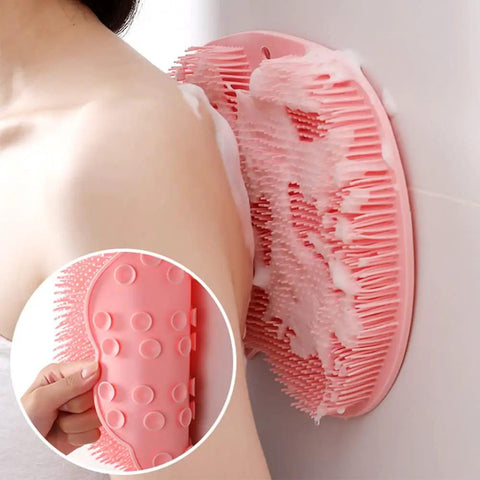 Wall mounted silicone scrubber pad with 500+ bristles, shown in use on a person's back, includes non-slip suction cups for shower or bath.
