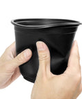 Hands squeezing a 4 Inch Plastic Nursery Pot from the 100 Pack With Drainage Holes For Seedlings, Cuttings, And Transplants, flexible material