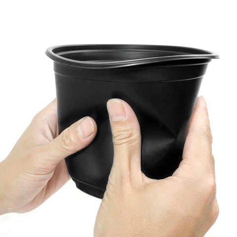 Hands squeezing a 4 Inch Plastic Nursery Pot from the 100 Pack With Drainage Holes For Seedlings, Cuttings, And Transplants, flexible material