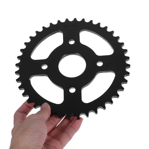 Hand holding Rear Sprocket Gear With Bore And Pitch For Dirt Bike And Electric Scooter Replacement Heavy Duty
