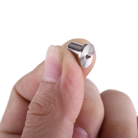 Hand holding a 6mm Steel Dowel Center from the Steel Dowel Center Set Eight Pieces For Precise Hole Alignment In Woodworking Hollow And Solid