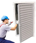 Installer uses a screwdriver on a Heavy Duty Aluminum Louvered Access Panel For Wall Ventilation And Plumbing Drywall Inspection Large 47 By 45 Inch.