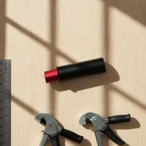 Retractable Table Stop for Woodworking, matte black with flush surface 20mm diameter, heavy duty metal, on light wood surface