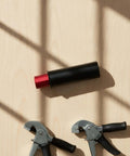 Retractable Table Stop for Woodworking Benches, Matte Black Bench Dog 20mm Diameter on table with tools and ruler