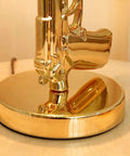 Close-up of gold pistol base of the Gold Gun Desk Light With Linen Shade, Modern Pistol Style Desk Lamp, Nordic Metal Craft.