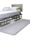 Hospital bed with Ultimate 70 Inch Bedside Fall Mat For Elderly Safety, Anti Slip Floor Protector beside it, non slip surface