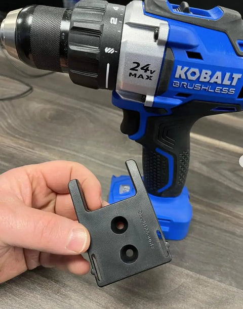 Close-up of Kobalt 24V tool with Locking Tool Holder For Kobalt 24V Tools, 4 Pack, Black, in hand on workbench.