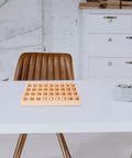 Dope Stackable Jewelry Organizer Tray Featuring Thirty Six Durable Wooden Grids For Sorting Beads Bracelets Pendants And Earrings on a table.