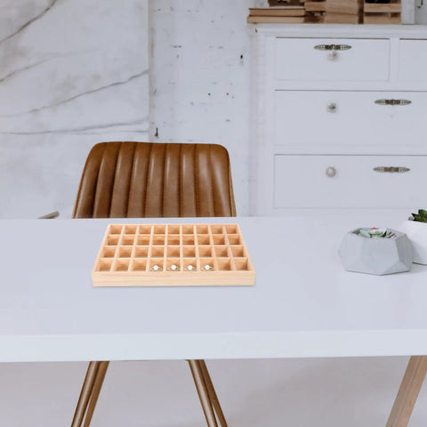 Dope Stackable Jewelry Organizer Tray Featuring Thirty Six Durable Wooden Grids For Sorting Beads Bracelets Pendants And Earrings on a table.