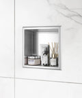 Stainless Steel Shower Niche 12x12 In Recessed Shelf Brushed Nickel Finish Waterproof Wall Storage Niche No Tile Needed Easy Install For Bathrooms In Wet Areas, installed in white tiled bathroom with products displayed.