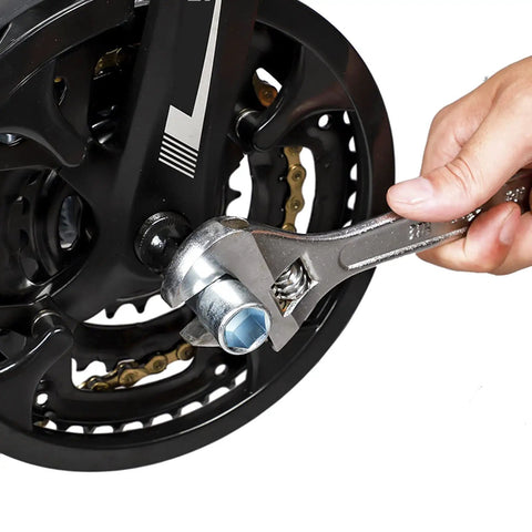 Hand using wrench on bike wheel from Six Piece Bicycle Repair Tools Kit For Mountain And Road Bikes, Pro Grade Cassette And Sprocket Removal Set