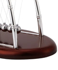 Close-up of Desktop Pendulum Balance Balls Desk Toy With Steel Frame, Classic Cradle Physics Demonstration Of Momentum And Energy