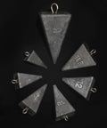 Set of pyramid lead fishing sinkers for saltwater 3oz each 5 pack beefy pyramid weights for long casts on black background