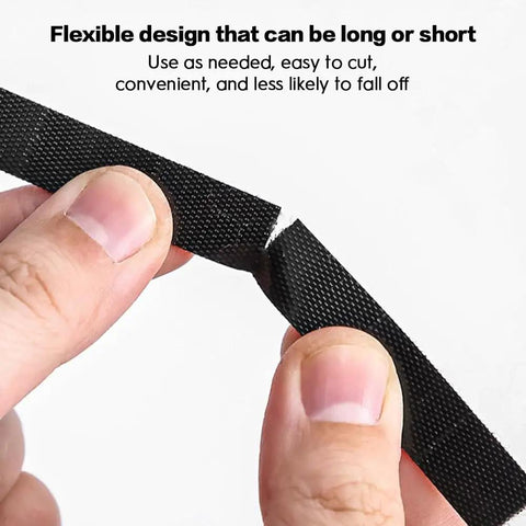 Close-up of hands cutting black Six Point Five Foot Two Roll Adjustable Cable Ties Reusable Hook and Loop Fastening for Cable Organizing.