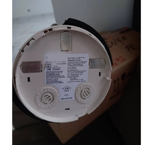 Professional Smoke Detector Removal Tool With A Slick Pole Attachment Gripper For High Ceiling Install And Quick Detachment Jobs That Are No Fuss Ace Rig In Red back of smoke alarm model FAPIT-851 with installation label