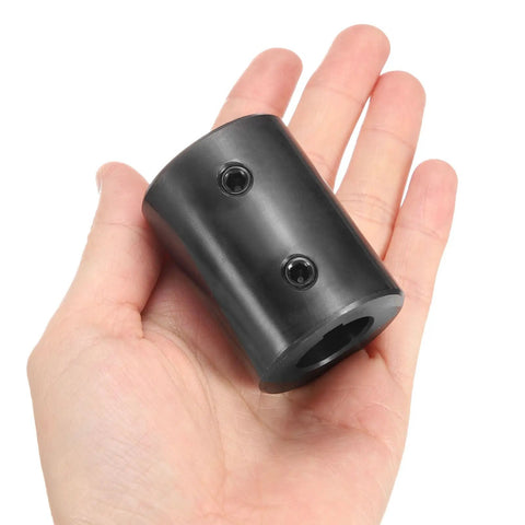 Rigid Shaft Coupling Built To Last For Motors And 3D Printers, Bore Three Quarters Inch, Outside Diameter One And Half Inch, Length Two Inches, Black Oxide Plated ASTM1045 Steel, With Two Set Screws, Durable High Precision Coupler, in hand