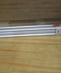 Rexroth Bosch TM-811000-03130 Pneumatic Cylinder, 12.5 inch stroke, 17 inch body, displayed with packaging on wooden surface