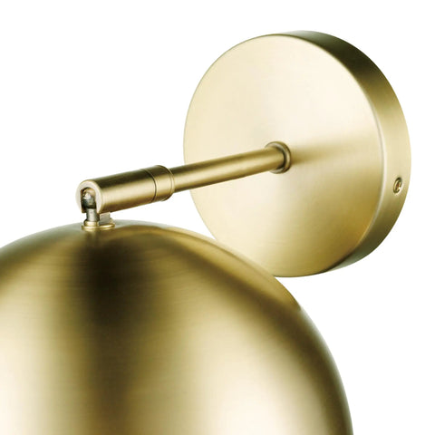 Detail of matte brass finish on one light plug in or hardwire wall sconce with vintage glam design.