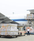 Cargo being loaded onto airplane with forklift, illustrating transportation concept.