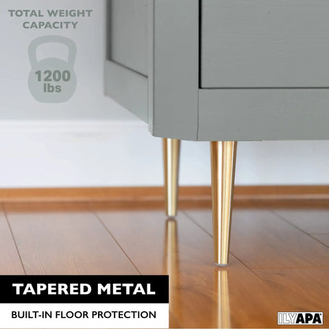 Gold Tapered Oblique Metal Furniture Leg Set Of 4 16 Inch Mid Century Modern Replacement Feet For Chairs Coffee Tables And Cabinets Heavy Duty Build Easy Install For DIY Upgrades shown supporting grey cabinet on wooden floor.