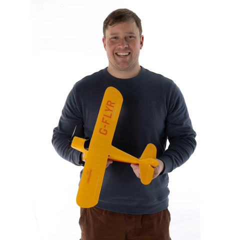 Champ Anniversary Edition 515mm RC Trainer Airplane BNF Basic With Safe Select held by a smiling person