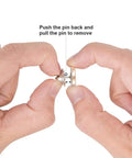 Hands demonstrating how to use 50 Piece Bulk Haul Of Top Shelf Metal Pin Backs Featuring Grip Tight Locking Clasps.