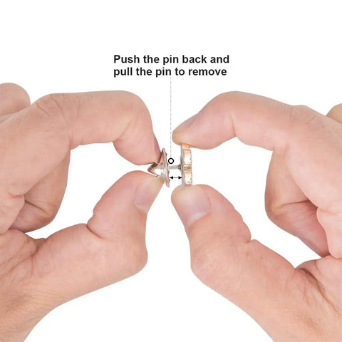 Hands demonstrating how to use 50 Piece Bulk Haul Of Top Shelf Metal Pin Backs Featuring Grip Tight Locking Clasps.