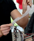 Close-up of a person holding a heavy duty plastic clothes hanger with a shirt on it. Part of Heavy Duty Plastic Clothes Hangers Set Of 12 For Wardrobe Organization Space Saving Crystal Clear Hangers For Shirts Blouses Dresses T Shirts Tees And Coats Ideal For Men And Women Closet Makeover.