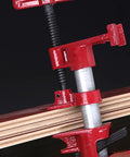 Heavy Duty Steel Pipe Clamps With Comfort Grip Rubber Sleeves, Quick Release Woodworking Screw Vise For Furniture Repairs And Rock Solid Panel Joints, Smooth Gluing Action No Sweat Professional Tool Kit close-up showing red steel clamp on wood panels.