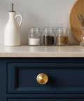 Champagne Bronze Cabinet Knobs Set Of 10 For Kitchen And Furniture, One And A Quarter Inch Single Hole Zinc Alloy Knobs installed on blue drawer