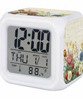 Fresh Spring Flower Printed Cube Digital Desk Clock Running Completely Silent With Sleek Date And Temp Screen Soft Glow Nightlight Mode And Auto Snooze For Chillin On Your Bedside Table Or Home Office Desk Setup, showing time and temperature.