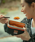 Flameless Self Heating Lunch Box Portable Food Warmer Oven 1200ml 40oz Capacity in use, heating a meal for outdoor dining.