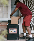 Delivery person placing a box in a Weather Resistant Aluminum Package Delivery Sign 8X12 Please Leave Packages Here For Carriers.