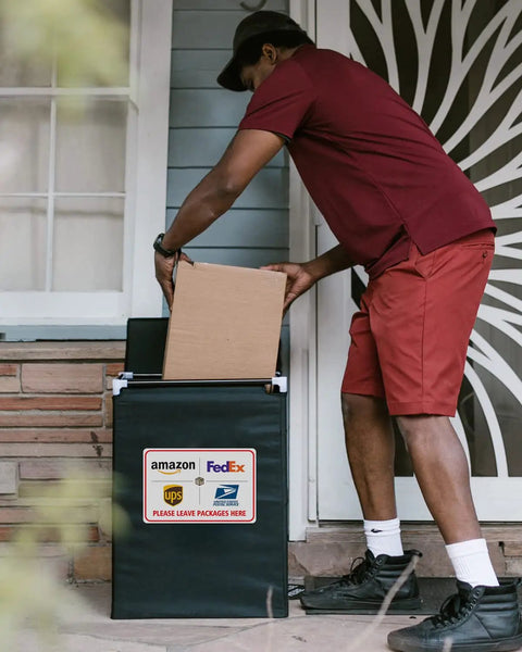 Delivery person placing a box in a Weather Resistant Aluminum Package Delivery Sign 8X12 Please Leave Packages Here For Carriers.