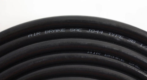 Close-up of black one quarter inch SAE J844 nylon air brake tubing with visible markings, coiled for truck brake systems.