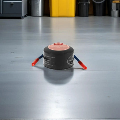 Vanzack Tiny Auto Fire Extinguisher For Car Engine And Garage Use Lightweight Alum Alloy Compact Emergency Safety Sprayer viewed from above on floor.