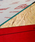 Cut Through Frost And Slush Fast With This High Temp Resistant Synthetic Ice And Snow Barrier Plus Heavy Duty Outdoor Ground Shield And Quick Roll Weather Protection Mats For Driveways close-up of red polypropylene edge with wooden texture.