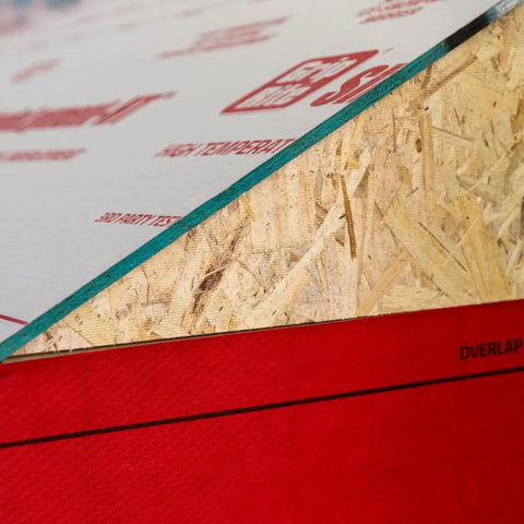 Cut Through Frost And Slush Fast With This High Temp Resistant Synthetic Ice And Snow Barrier Plus Heavy Duty Outdoor Ground Shield And Quick Roll Weather Protection Mats For Driveways close-up of red polypropylene edge with wooden texture.