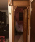 Slick Bookshelf Hidden Door Hinge System DIY Kit for Man Cave and Play Room shown in a doorway with wooden frame.
