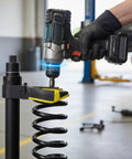 Heavy Duty MacPherson Strut Spring Compressor Tool Kit With Impact Wrench Compatibility in use on car suspension coil.