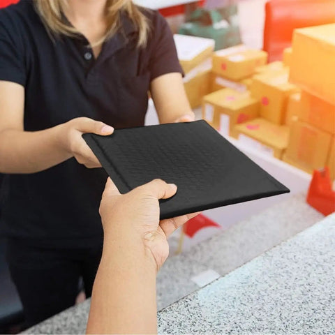 Handing over Black Bubble Mailers 6x10 Inch Outer, Usable 6x9 Inch, 4.6mm Thick Waterproof Padded Envelopes For Shipping in a store