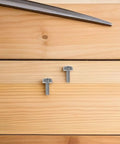 M6x20 Nickel Plated Crown Head Rack Screws on wooden surface, part of Cage Nuts Kit for Server Racks and Network Switches