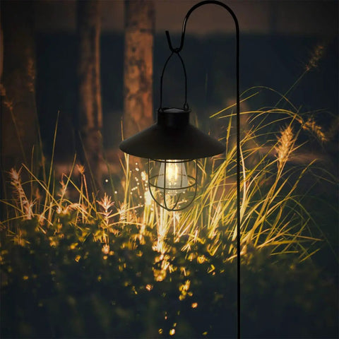 Solar Lantern Outdoor Hanging Light, Metal Solar Lamp With Warm White Edison Bulb illuminating garden, black finish at night