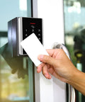 Rock Solid Stand Alone Door Access Control Keypad With 125 Khz Proximity Reader And Password Code Combo Including Five Heavy Duty Key Fob Tags For Bulletproof Gate Opener Security And No Fuss Install, hand using card.