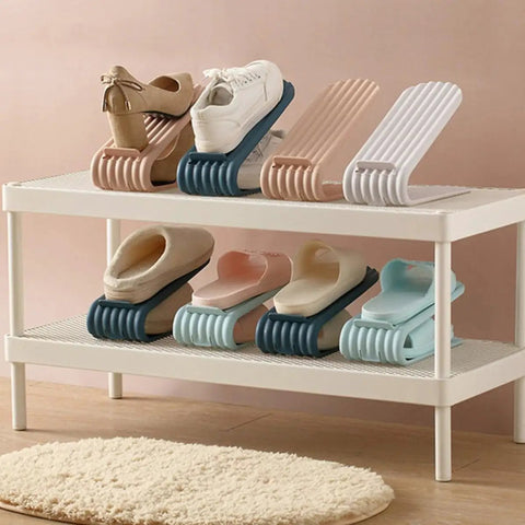 Double Deck Vertical Shoe Slot Organizer With Adjustable Two Tier Design showing assorted shoes on a white shelving unit.