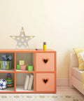 Star Shaped LED Marquee Light With 11 Warm White LEDs on orange shelf in cozy bedroom setting.
