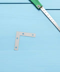 100 Piece L Shaped Corner Bracket Set For Wood Furniture And Frames, Heavy Duty Iron Joining Repair Plates, shown with ruler