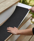 Applying 8-Pack Non Slip Outdoor Stair Treads For Steps And Decks 8x30 Inch Grip Tape Adhesive Strips on wooden stairs
